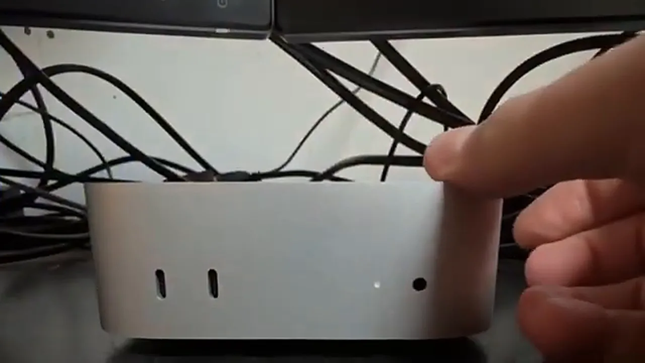 Mac mini auto start Mac mini auto start - lifting the Mac mini to reach the power button on its underside